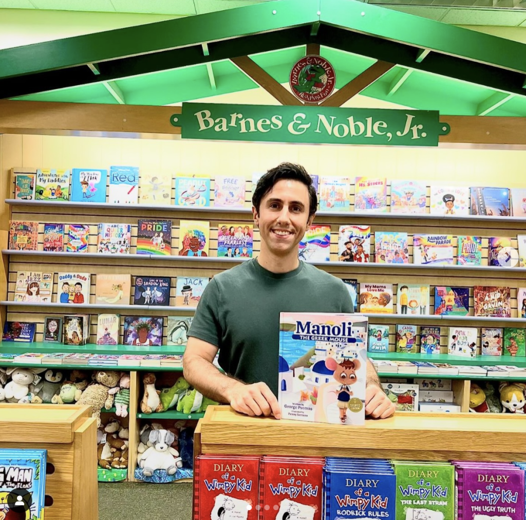 A man standing in front of a book case.